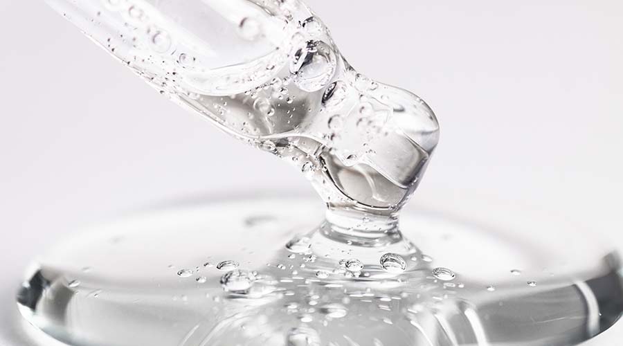 Goutte d'acide hyaluronique en gros plan, ingrédient hydratant star des soins visage naturels et bio IUM Paris, pour une peau repulpée et lumineuse.